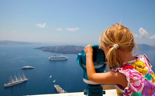 Girl looking at cruise ships (stock)
