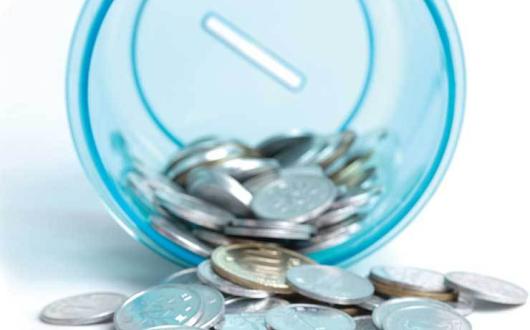 Money in a piggy bank cup