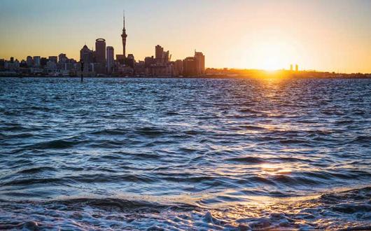 Auckland skyline sunset over sea