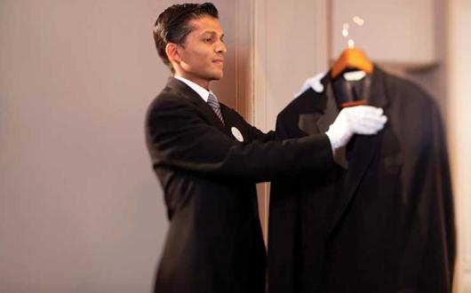 Butler combing a jacket
