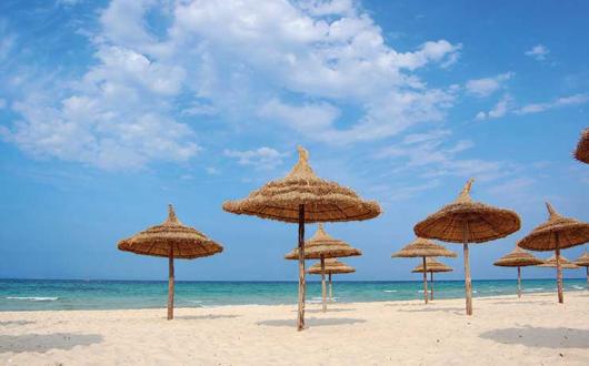 Parasols on the beach in Tunisia iStock-95341294