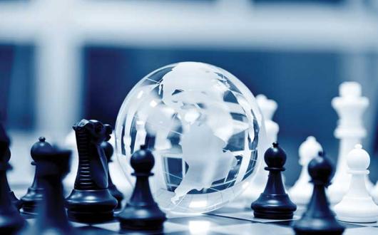 Globe and chess pieces strategy theme iStock-485959046