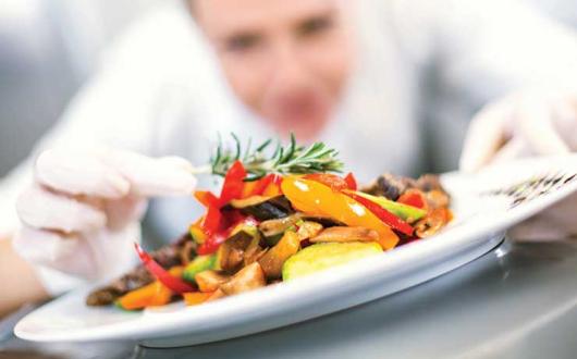 Chef applying finishing touches to dish iStock-495799458