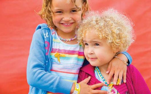 Phoebe (left) was helped by research funded by Children with Cancer UK