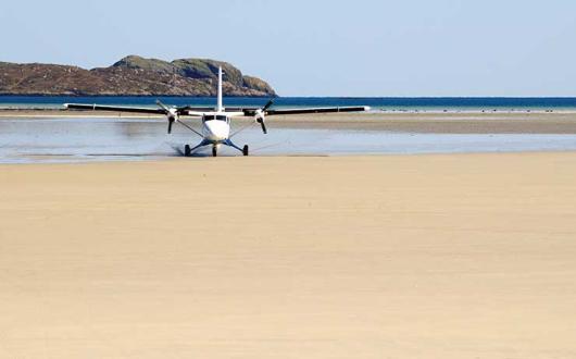 Light aircraft landing on beach iStock-174798675