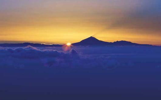 Sunset over mountain and cloud horizon