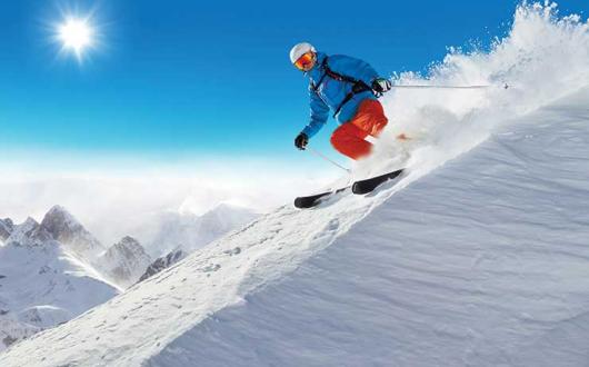 Downhill skier in the sun