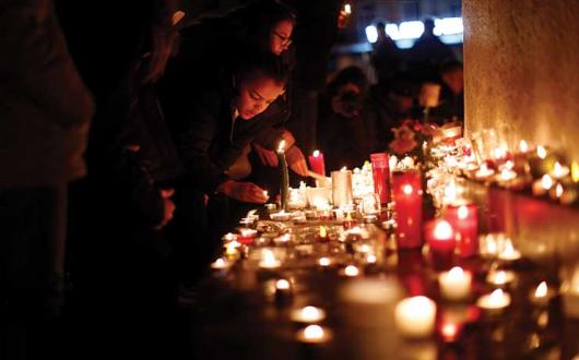 Mourners pay their respects. Photo Credit: Getty Images