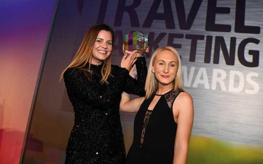Travel Marketing Awards winners showing trophy