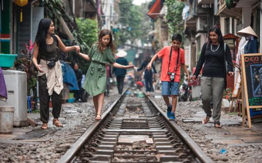 G Adventures National Geographic Vietnam Hanoi Train Street Mothers Children Walking.jpg