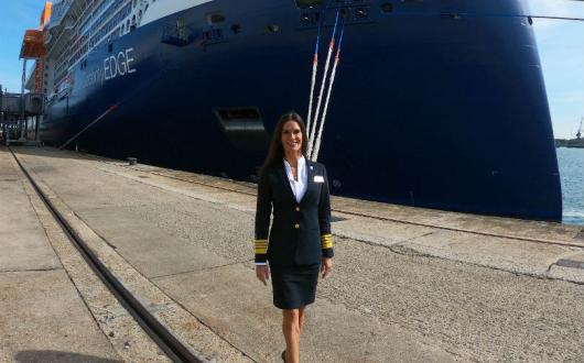 Captain Kate McCue beside Celebrity Edge