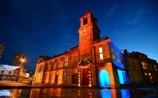 Several city landmarks have been lit up in blue and orange in tribute to John Hays