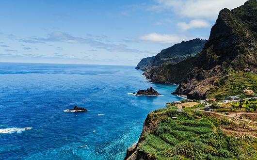 Madeira's beautiful coastline features verdant cliffs and azure waters (Credit: Stephen Lammens/Unsplash)
