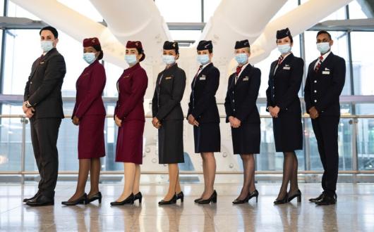 Cabin crew from British Airways and Qatar Airways celebrate plans to expand the two carriers' joint business