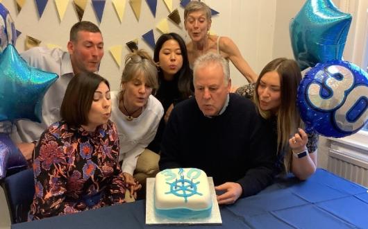 Rupert Thomson celebrates with some of the Light Blue Travel team