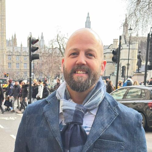 Man smiling in front of Big Ben 