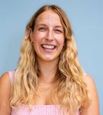Young white woman with long wavy blonde hair smiling at camera 