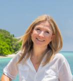 Blonde woman smiling with sea background 