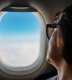 A passenger looks out the window of an aircraft