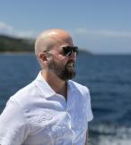 Man with sunglasses looking out to sea 