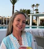 Smiling woman with long brown hair on holiday