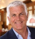 Professional photo of white man smiling with short white hair 