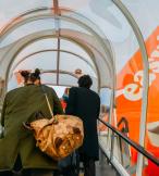 Passengers board an easyJet aircraft