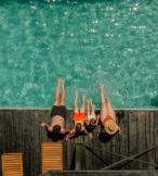 A family relaxing by a pool on holiday