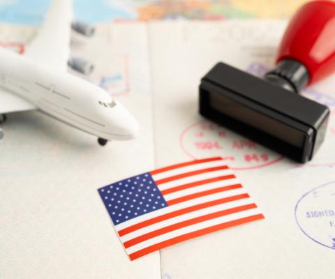 A mock up of an aircraft with a US flag and passport stamp