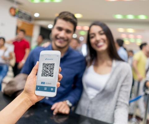 Two people present a QR code to get into an event