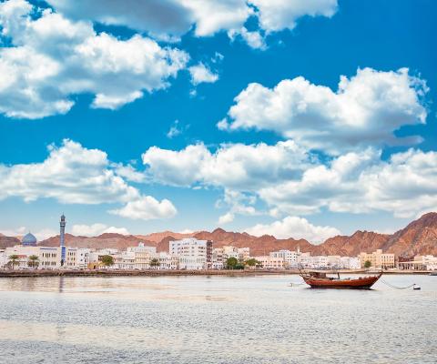 View of Oman coastline with boat in foreground