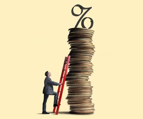 A man looks up as he leans a red ladder against a tall stack of coins that is topped with an interest rate symbol.
