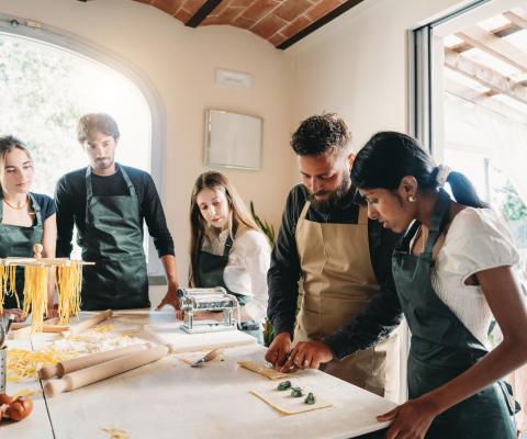 Young travellers pasta making class in Italy