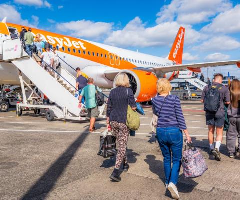 Passengers board an easyJet aircraft