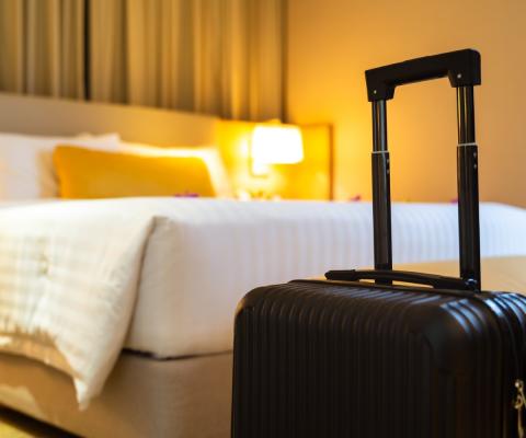 A suitcase delivered to a hotel room