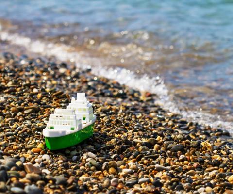 A small plastic ship on the shore