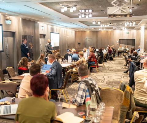 Travel agents sitting around two long tables speaking with Namibia partners at networking event