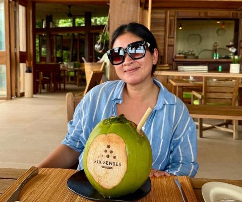 Nong Skett drinking from a coconut