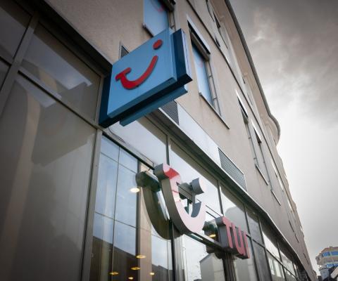 A tui shop pictured with the smile logo on the side of the building