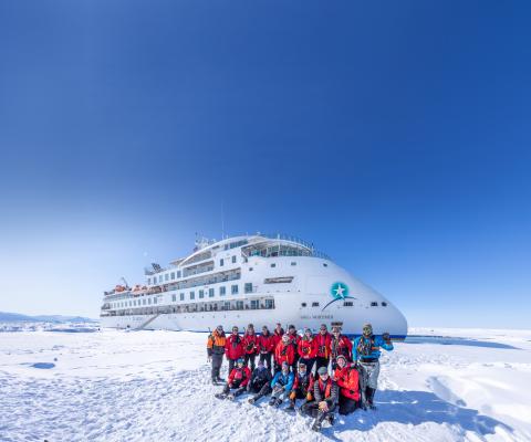 Group Photo in front of Greg Mortimer ship
