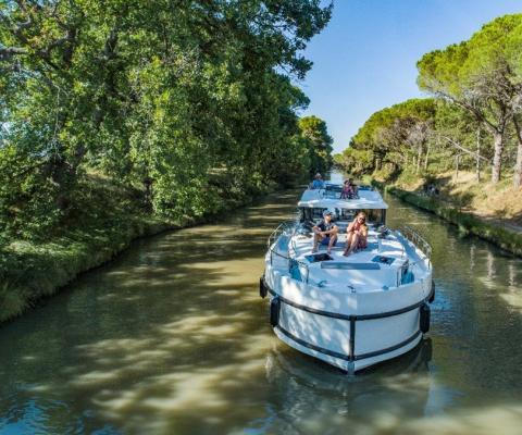 Travellers enjoy soaking up the sun on a river boat cruise