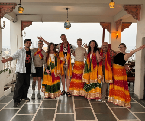 The TTG Travel Ambassadors smile at the camera wearing traditional Bollywood skirts and scarfs 