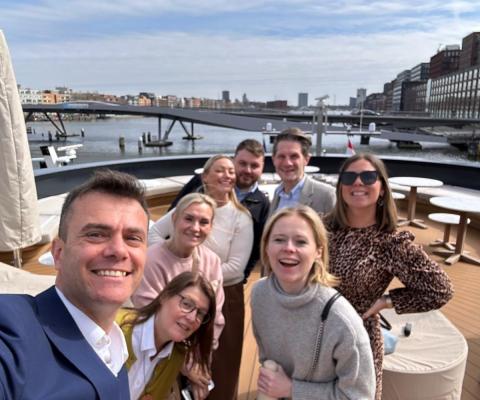 Group of people smiling on ship 