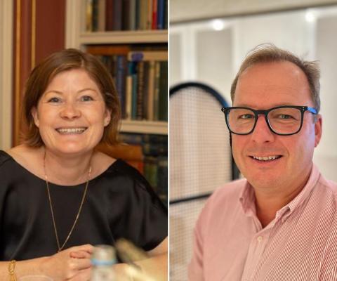 Woman with short brown hair smiling and man with glasses smiling 