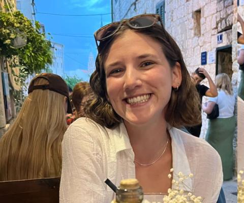 Smiling woman with shoulder-length brown hair 