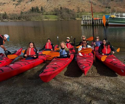 Five women in red kayaks 