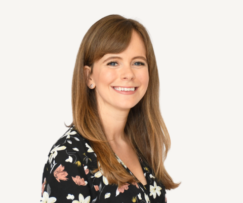 Woman with long brown hair smiling 