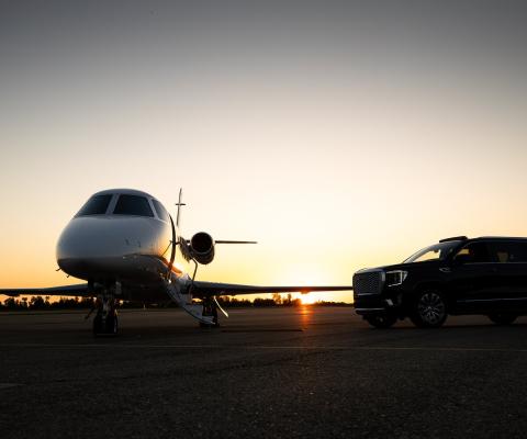 A private jet sitting on a runway at dusk