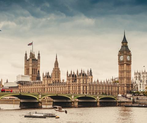 An aircraft flies over the UK parliament in London
