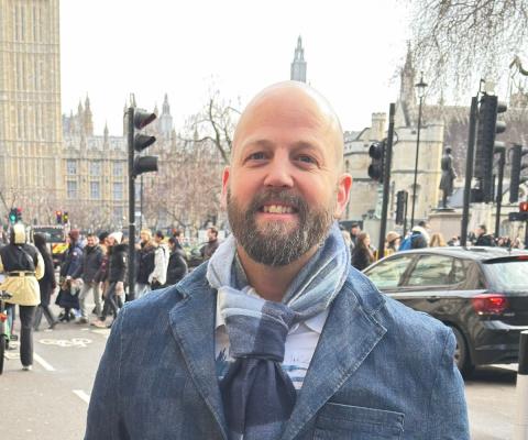Man smiling in front of Big Ben 
